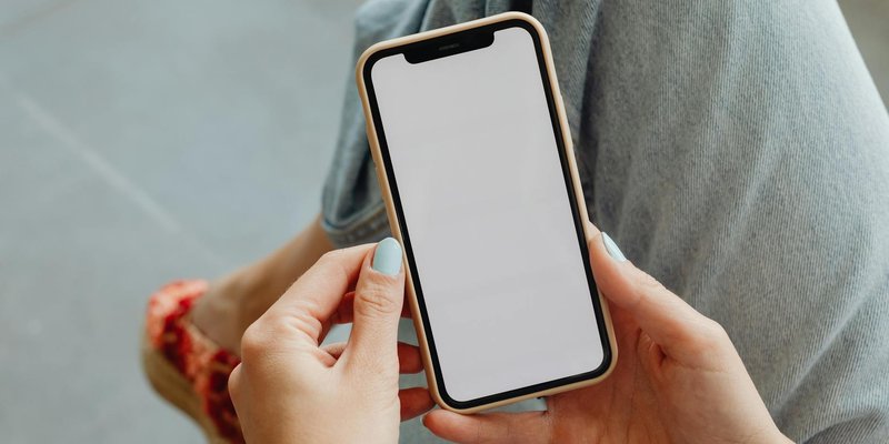 Woman holding smartphone with blank screen, perfect for app mockups or design presentations.
