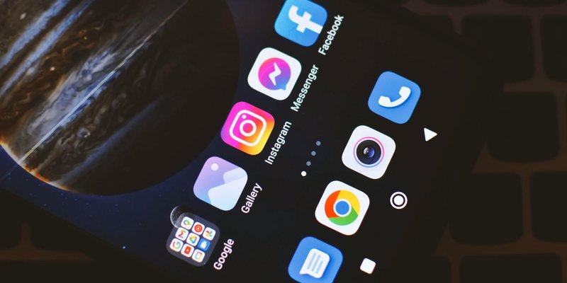Smartphone screen showing popular social media and app icons including Facebook and Instagram.