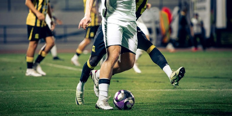 Close-up of soccer players in action during a match at an outdoor stadium.