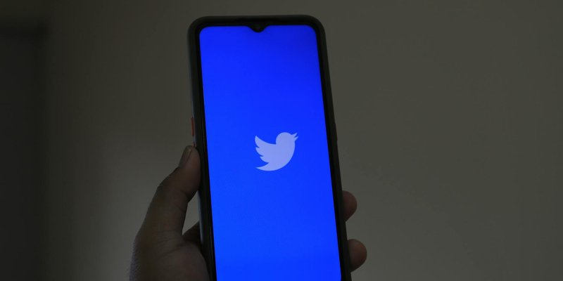 A close-up of a smartphone displaying the Twitter app, emphasizing digital connection and modern tec