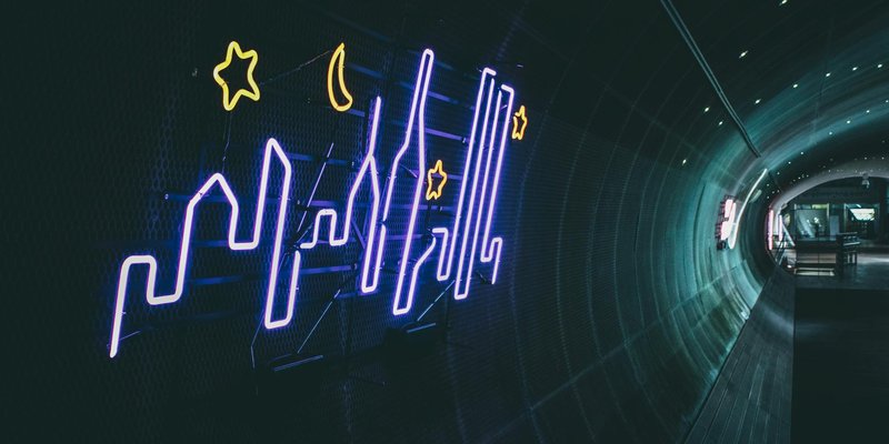 Vibrant neon skyline artwork illuminating a tunnel in Seoul, South Korea.